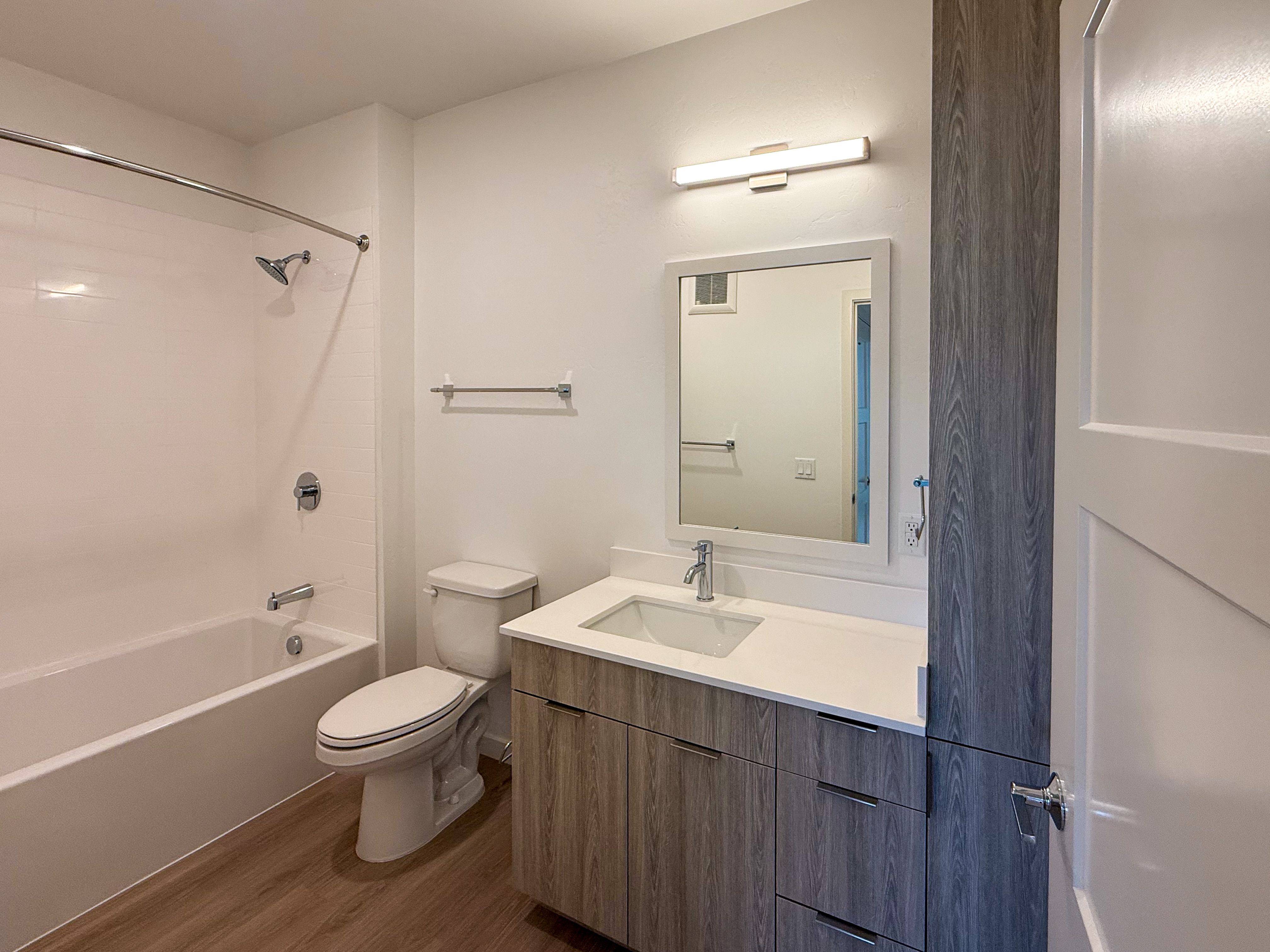 A white toilet sits next to a sink in a bathroom.